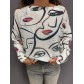 Top pull oversize imprimé visages yeux bouches