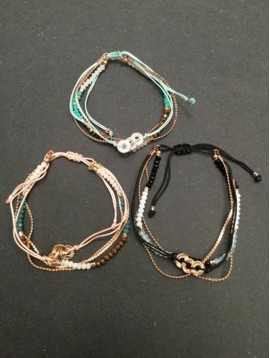 Bracelet - Sliding style multi row with metallic rings charms.